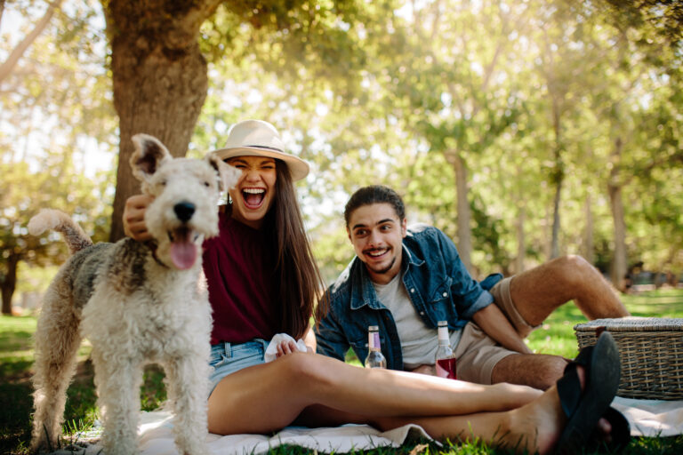 Dating and pets - couple on picnic with pet dog